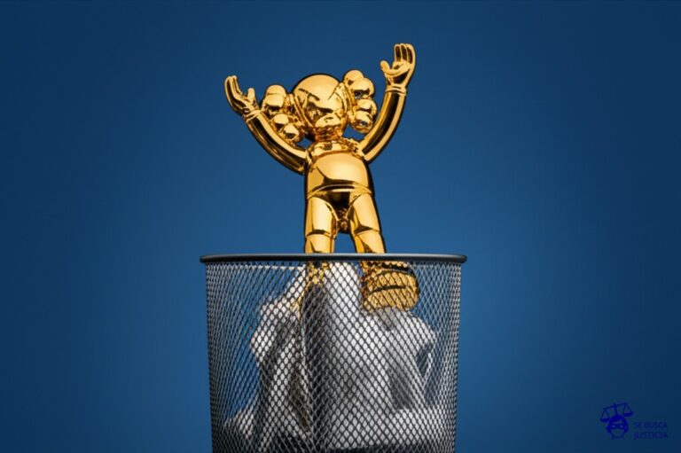 Un cubo de basura rebosante con una escultura de juguete dorada asomando por encima. Representa: Damien Hirst fue acusado de plagiar ideas en varias obras incluyendo 'Hymn' y 'The Physical Impossibility of Death'