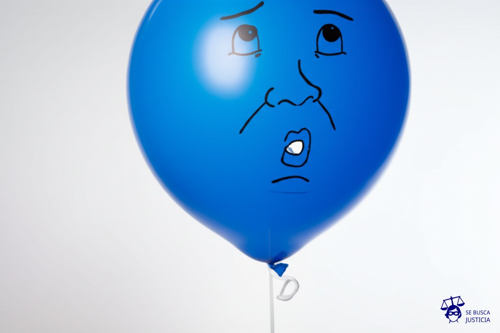 Un globo inflado con forma de cabeza humana, que se desinfla lentamente por una fuga en la boca, mientras los ojos miran hacia arriba con expresión de estupor. Representa: Intoxicación por fuga de gas