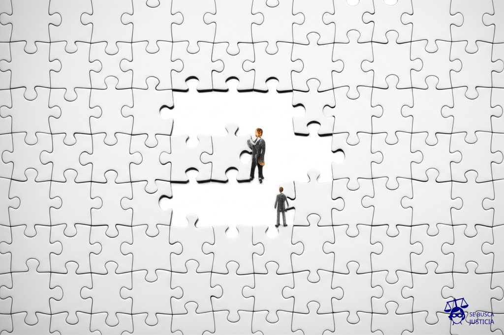 Un enorme rompecabezas con piezas idénticas, pero con un hombre intentando encajar una pieza en un lugar donde claramente no encaja. Representa: Controversia sobre la validez de un acuerdo de extradición entre dos países
