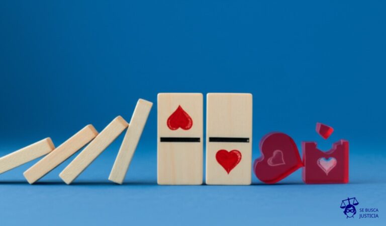 Un dominó con una figura de corazón pintada en su superficie es empujado. Cae y golpea un dominó más pequeño, también con forma de corazón, que se rompe en pedazos. Representa: Un cónyuge, en medio de una discusión violenta, empuja al otro, quien cae y se golpea la cabeza, falleciendo. La fiscalía califica el hecho como homicidio agravado por el vínculo. La defensa argumenta un homicidio preterintencional, señalando que no existía intención de matar, sino solo de lesionar, y que el resultado fatal fue un desenlace accidental y no buscado.